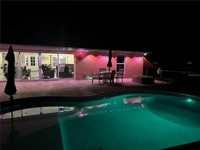 9950 NW 11th Ter, Ocala, FL 34475 - pool at twilight featuring a patio and an outdoor pool