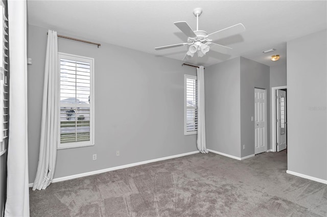 empty room featuring baseboards, a ceiling fan, and carpet floors