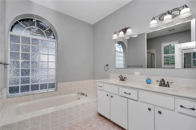 bathroom with a shower with shower door, a garden tub, double vanity, and a sink