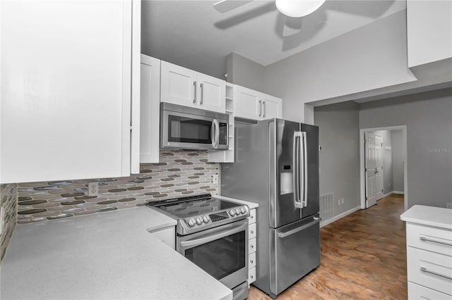 kitchen with stainless steel appliances, tasteful backsplash, light countertops, and a ceiling fan
