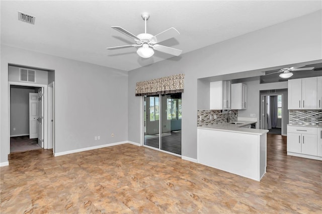 kitchen featuring a sink, visible vents, ceiling fan, and decorative backsplash