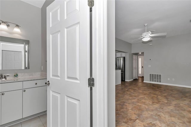 bathroom with visible vents, ceiling fan, vanity, and baseboards