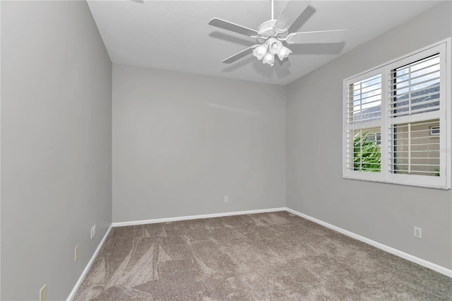 spare room featuring baseboards, a ceiling fan, and carpet flooring