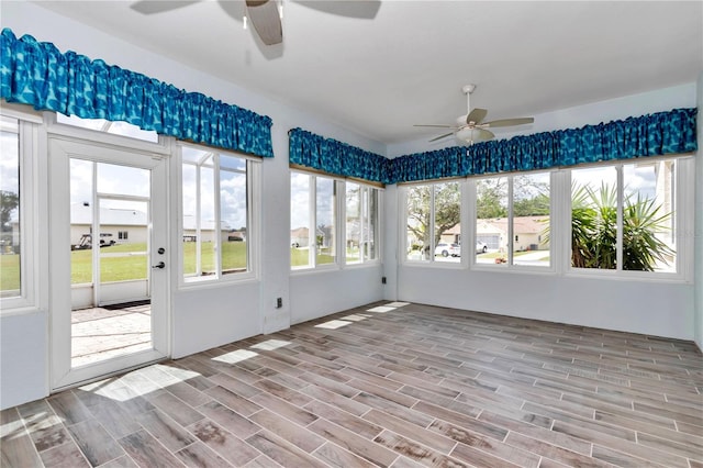 unfurnished sunroom featuring a wealth of natural light and wood finished floors