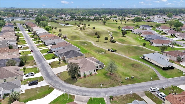 drone / aerial view featuring golf course view and a residential view