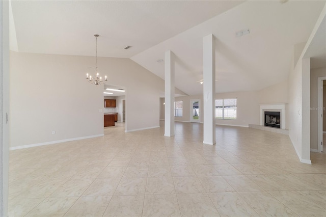 9896 SW 56th Ct, Ocala, FL 34476 - unfurnished living room with a tiled fireplace, baseboards, an inviting chandelier, and lofted ceiling