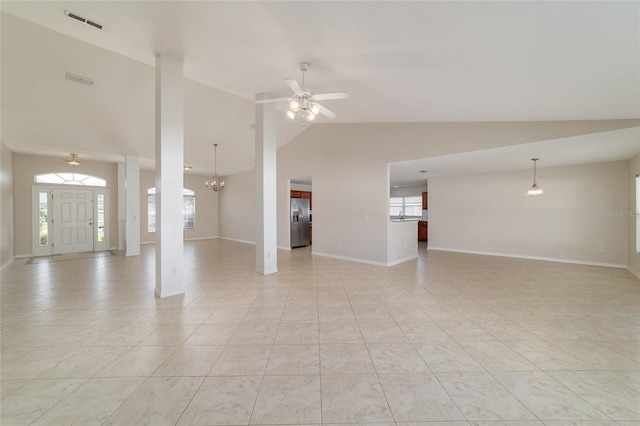 9896 SW 56th Ct, Ocala, FL 34476 - unfurnished living room with baseboards, vaulted ceiling, light tile patterned floors, visible vents, and ceiling fan with notable chandelier
