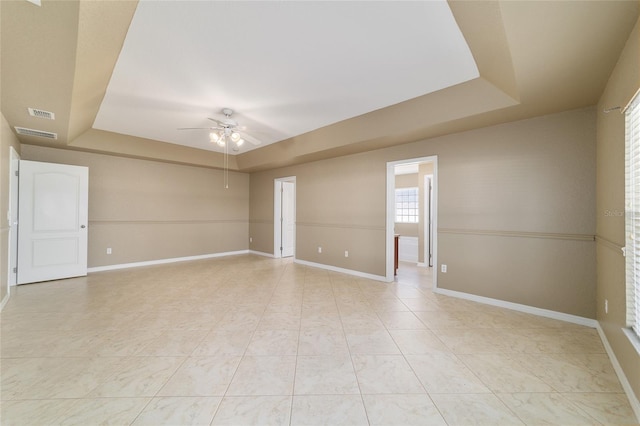 9896 SW 56th Ct, Ocala, FL 34476 - empty room featuring baseboards, a tray ceiling, and a ceiling fan