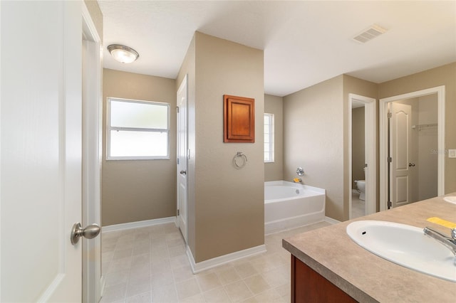 9896 SW 56th Ct, Ocala, FL 34476 - full bath with toilet, a garden tub, visible vents, and a wealth of natural light