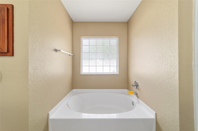 9896 SW 56th Ct, Ocala, FL 34476 - bathroom featuring a textured wall and a bath