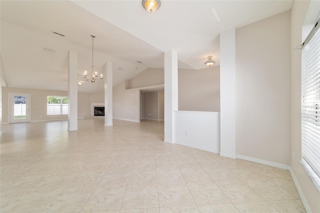 9896 SW 56th Ct, Ocala, FL 34476 - unfurnished living room with baseboards, a fireplace with raised hearth, a notable chandelier, and vaulted ceiling
