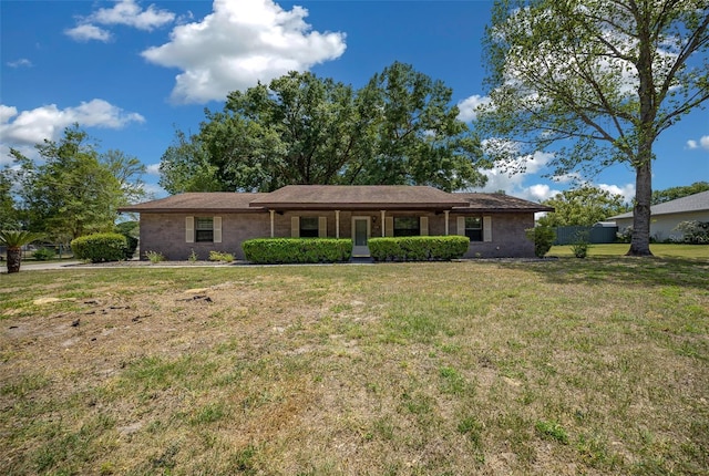 single story home featuring a front lawn and brick siding