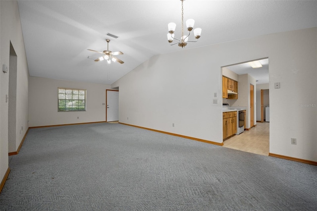 empty room with light colored carpet, lofted ceiling, baseboards, a ceiling fan, and a chandelier