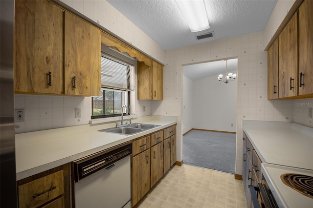 kitchen with dishwasher, a sink, a textured ceiling, light countertops, and brown cabinetry