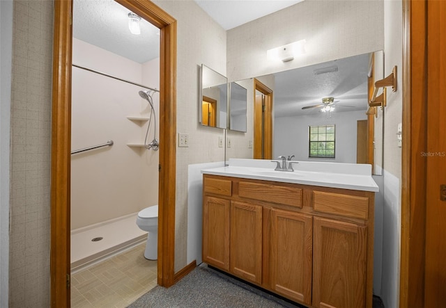 full bathroom featuring a ceiling fan, a shower, vanity, and toilet