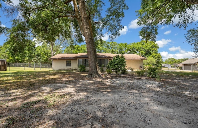 back of property with fence and stucco siding