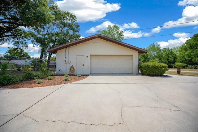 view of front of home with a garage, fence, and driveway