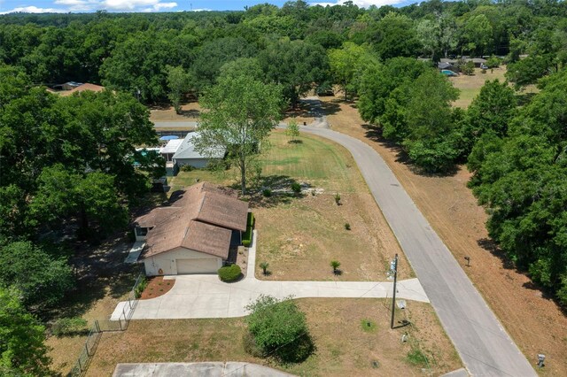 view of subject property with a heavily wooded area