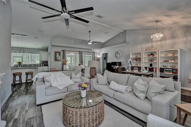 7407 SW 202nd Ct, Dunnellon, FL 34431 - living area with dark wood finished floors, a ceiling fan, vaulted ceiling, and a chandelier