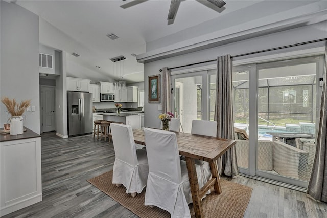 7407 SW 202nd Ct, Dunnellon, FL 34431 - dining area featuring ceiling fan, wood finished floors, and vaulted ceiling