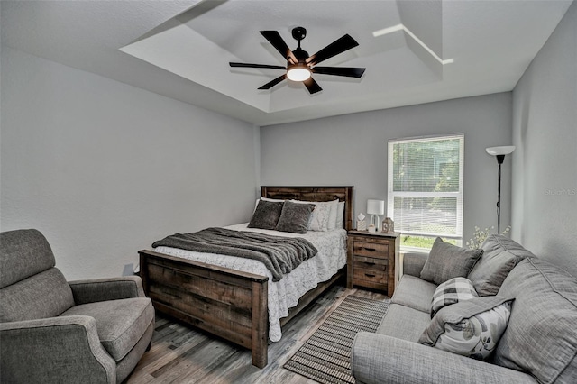 7407 SW 202nd Ct, Dunnellon, FL 34431 - bedroom with wood finished floors, a tray ceiling, and ceiling fan