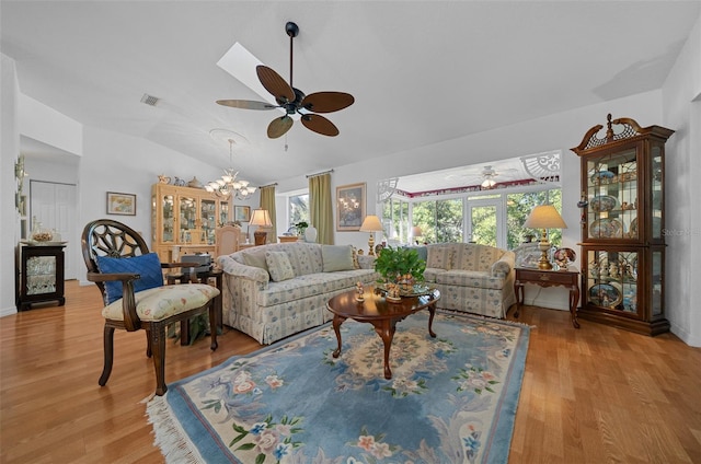 7692 SW 117th Street Rd, Ocala, FL 34476 - living area with ceiling fan with notable chandelier, wood finished floors, lofted ceiling, and plenty of natural light