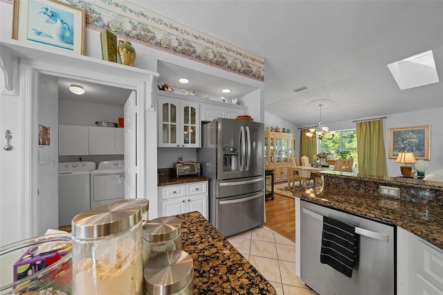 7692 SW 117th Street Rd, Ocala, FL 34476 - kitchen with glass insert cabinets, stainless steel refrigerator with ice dispenser, a skylight, beverage cooler, and washer and dryer
