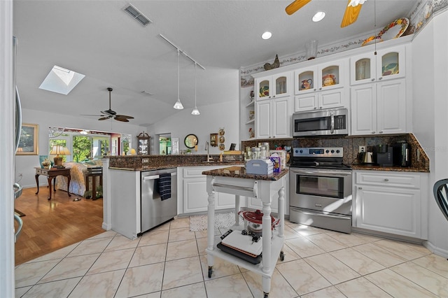 7692 SW 117th Street Rd, Ocala, FL 34476 - kitchen featuring ceiling fan, rail lighting, a peninsula, visible vents, and stainless steel appliances