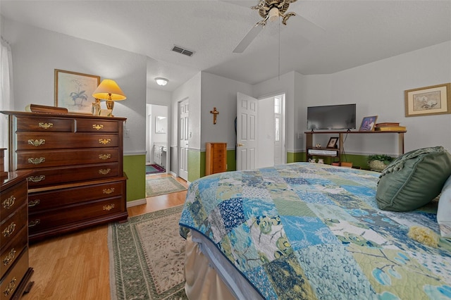 7692 SW 117th Street Rd, Ocala, FL 34476 - bedroom featuring visible vents, baseboards, a ceiling fan, light wood finished floors, and ensuite bath