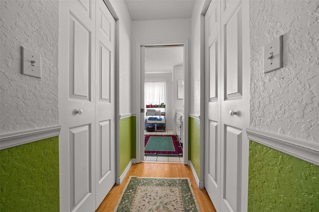 7692 SW 117th Street Rd, Ocala, FL 34476 - hall featuring a textured wall and light wood finished floors