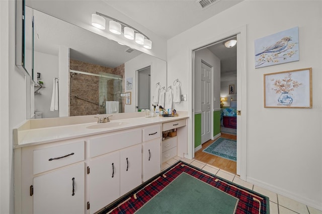 7692 SW 117th Street Rd, Ocala, FL 34476 - bathroom with vanity, visible vents, a stall shower, baseboards, and tile patterned floors