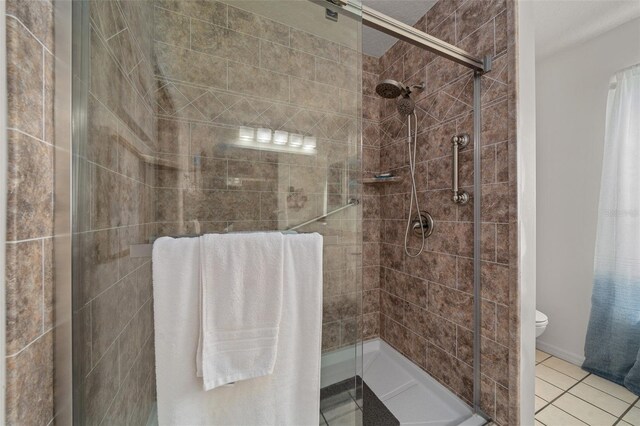 7692 SW 117th Street Rd, Ocala, FL 34476 - bathroom with toilet, a shower stall, and tile patterned flooring