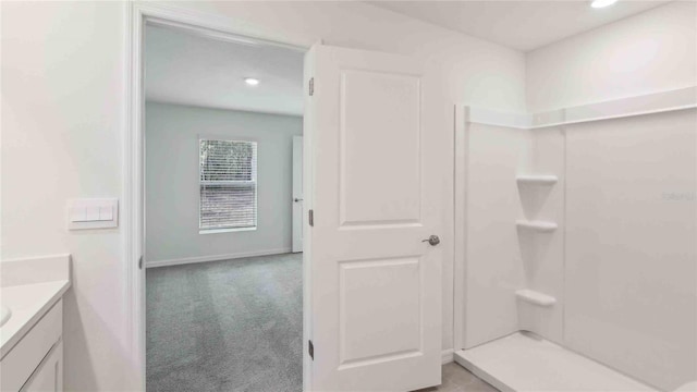 full bathroom featuring recessed lighting, baseboards, walk in shower, and vanity