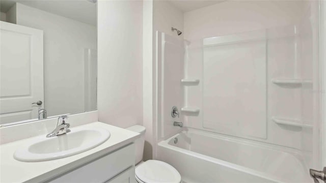 bathroom featuring vanity, washtub / shower combination, and toilet