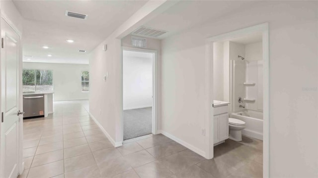 hallway with recessed lighting, baseboards, visible vents, and light tile patterned floors