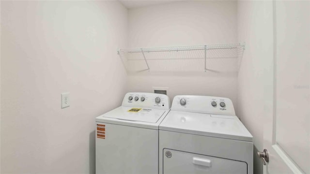 washroom with separate washer and dryer and laundry area