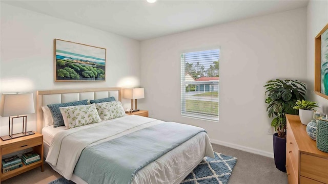 carpeted bedroom featuring baseboards