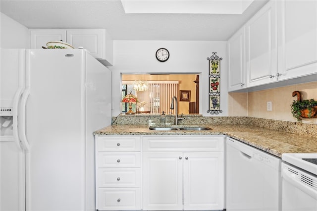 2756 Clubhouse Dr Unit 101, Sarasota, FL 34232 - kitchen featuring a sink, white cabinets, tasteful backsplash, and white appliances