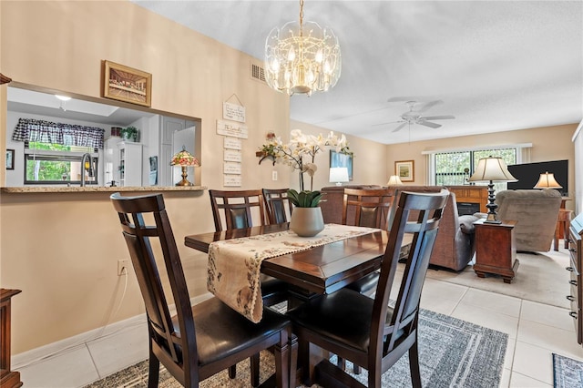 2756 Clubhouse Dr Unit 101, Sarasota, FL 34232 - dining room featuring ceiling fan with notable chandelier, light tile patterned flooring, and plenty of natural light
