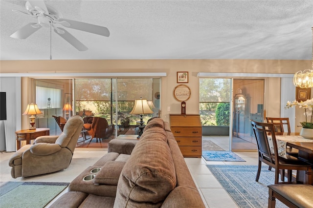 2756 Clubhouse Dr Unit 101, Sarasota, FL 34232 - tiled living room featuring a textured ceiling and ceiling fan with notable chandelier