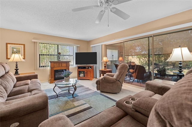 2756 Clubhouse Dr Unit 101, Sarasota, FL 34232 - living area featuring a ceiling fan, a glass covered fireplace, and a textured ceiling