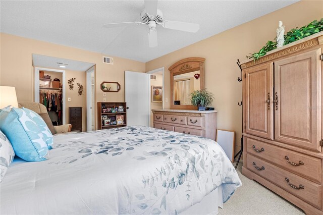 2756 Clubhouse Dr Unit 101, Sarasota, FL 34232 - bedroom featuring visible vents, a closet, ceiling fan, a walk in closet, and light colored carpet