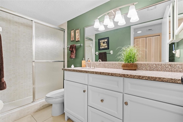 2756 Clubhouse Dr Unit 101, Sarasota, FL 34232 - full bathroom featuring vanity, tile patterned floors, a textured ceiling, toilet, and a shower stall
