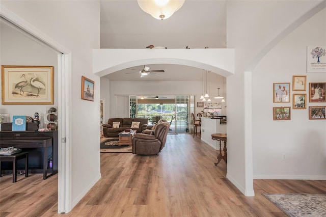 4277 E Bennett St, Inverness, FL 34453 - corridor with arched walkways, a towering ceiling, and light wood-style floors