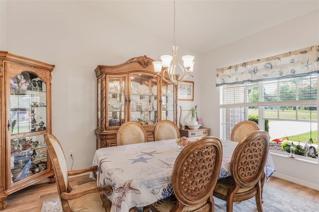 4277 E Bennett St, Inverness, FL 34453 - dining area featuring a chandelier, light wood-type flooring, baseboards, and lofted ceiling