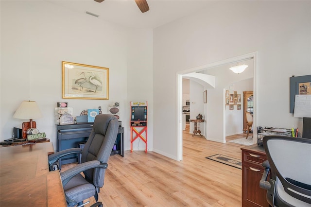4277 E Bennett St, Inverness, FL 34453 - office area featuring a towering ceiling, light wood-style flooring, visible vents, ceiling fan, and arched walkways