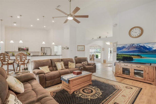 4277 E Bennett St, Inverness, FL 34453 - living room featuring visible vents, arched walkways, a ceiling fan, light wood finished floors, and high vaulted ceiling