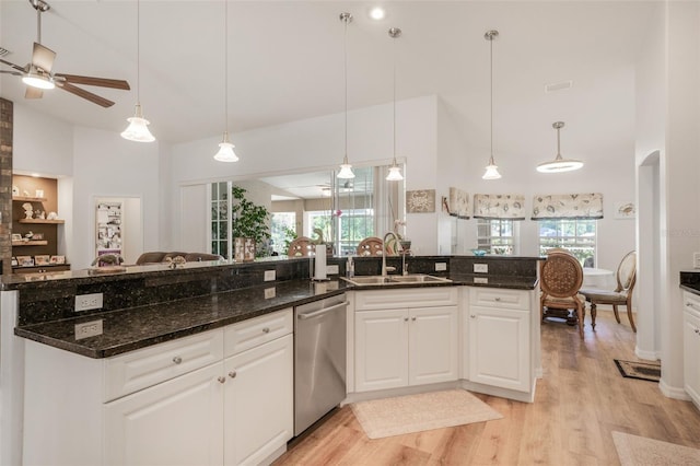 4277 E Bennett St, Inverness, FL 34453 - kitchen with high vaulted ceiling, open floor plan, stainless steel dishwasher, light wood finished floors, and a sink