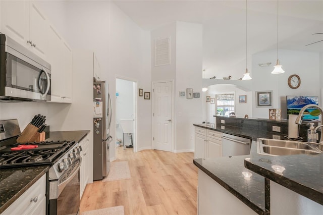 4277 E Bennett St, Inverness, FL 34453 - kitchen featuring a sink, appliances with stainless steel finishes, light wood finished floors, and a towering ceiling