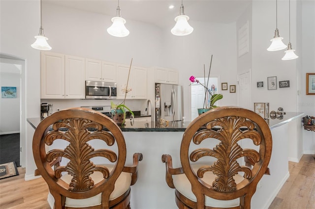 4277 E Bennett St, Inverness, FL 34453 - dining room with high vaulted ceiling, light wood-style flooring, and baseboards